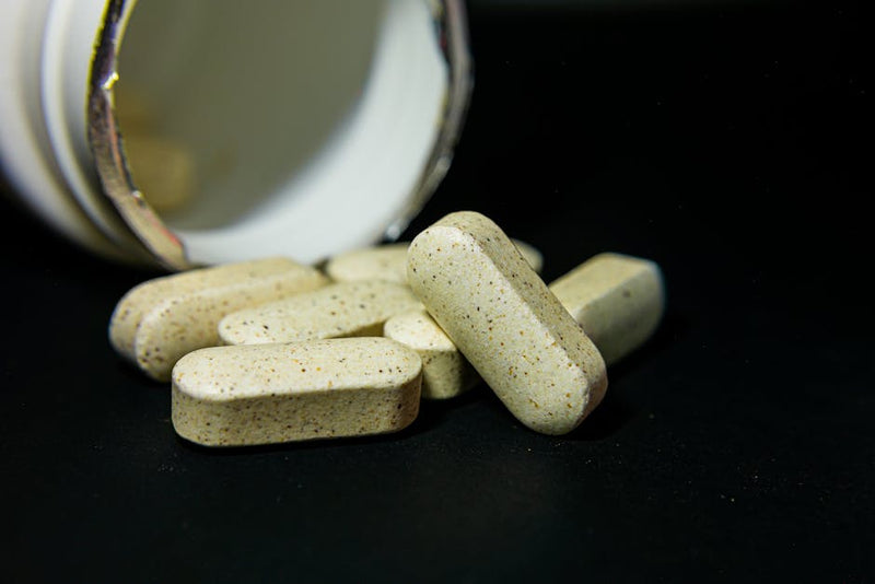NMN supplement capsules and pills representing safe supplementation for longevity and health